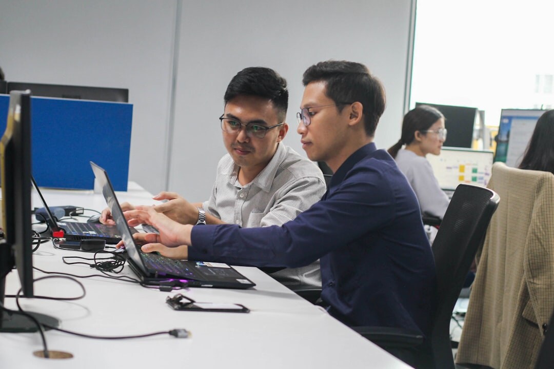 Diverse marketing team analyzing digital campaign dashboards on screens in a Brussels office